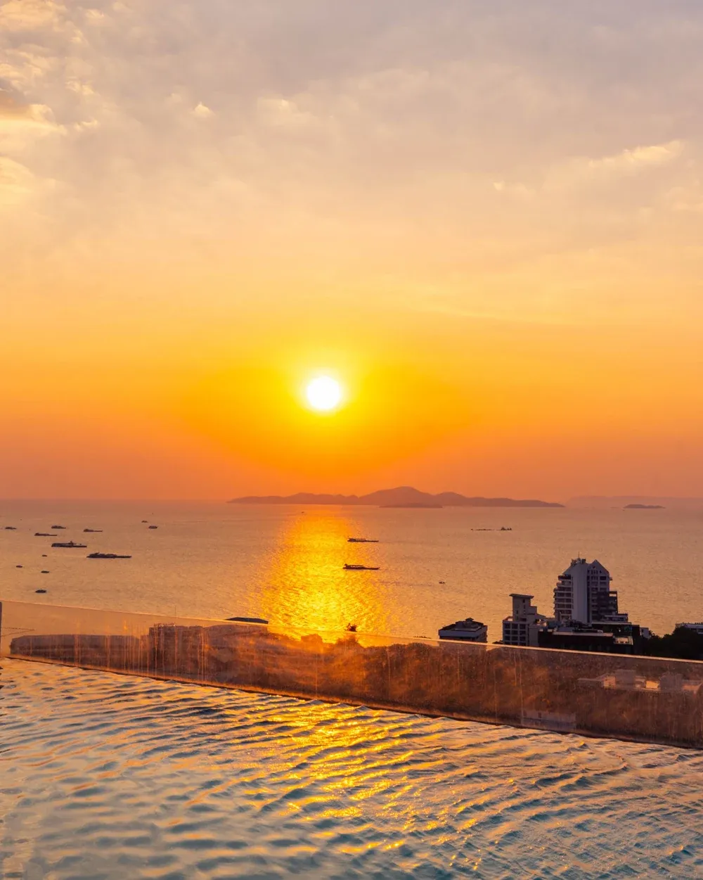 Sunset over the Akara Pattaya rooftop pool